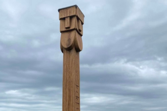 Wood carved face of mysterious totem pole that appeared at Capel-le-Ferne nature reserve in Kent