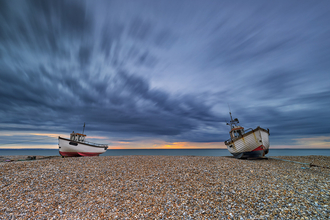 Sunrise at Dungeness with two boats on the shingle in low tide