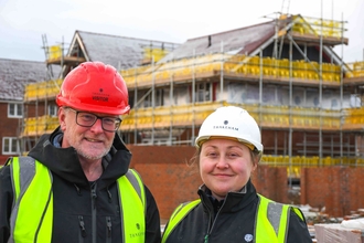 Rob Smith & Josie Cadwallader-Hughes in hard hats at a Thakeham site under construction.