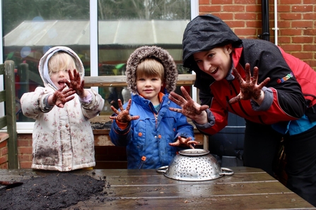children playing with mud pies