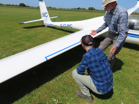 Adrian showing Lawrence marked area on glider wing to use as survey area for Bugs Matter