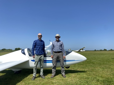Lawrence and Adrian alongside glider after visit to gliding club for Bugs Matter