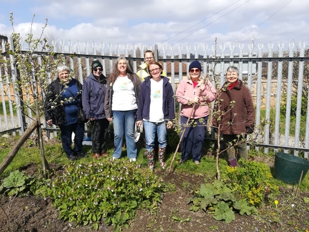 Community group members of Transition Dover standing in front of a planting area
