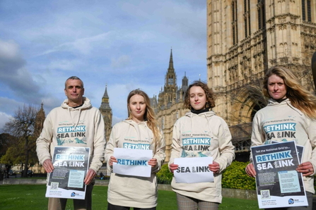 Four Kent Wildlife Trust employees outside the Houses of Parliament in Rethink Sea Link hoodies.