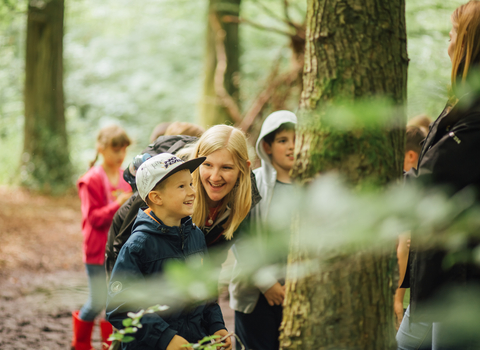 Children and families in the woods, photo by Helena Dolby for Sheffield & Rotherham Wildlife Trust