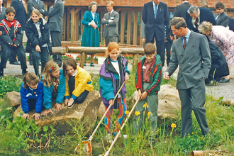 The then Prince Charles, observes some children pond dipping at the opening of Tyland Barn in 1993