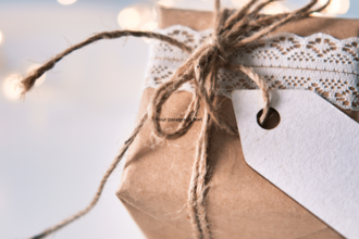 Christmas present wrapped in brown paper and tied with twine showing that you can wrap with recyclable materials