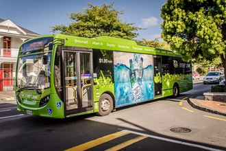 Green Bus driving on street
