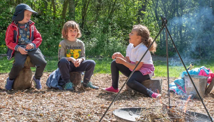 children gathered around campfire laughing