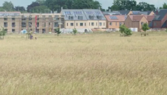 View of houses across agricultural land