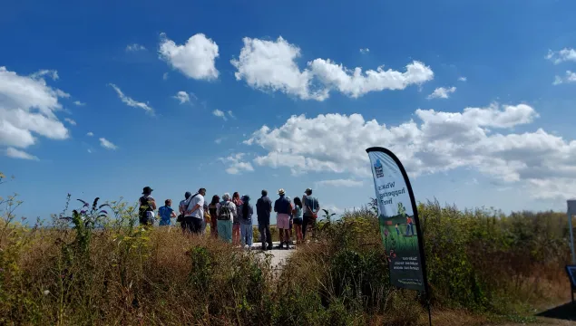 walkers on a guided walk at pegwell bay in the sun