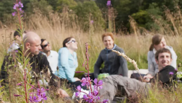 People lying together in the grass