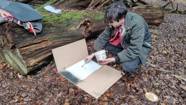 A person setting up a track plate.