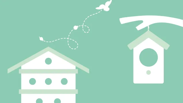 A bug hotel next to a hanging bird box