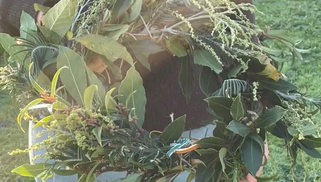 A willow wreath covered with winter foliage