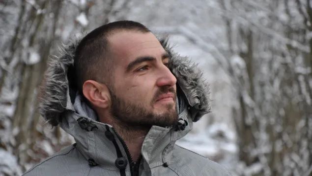 man in woods in winter