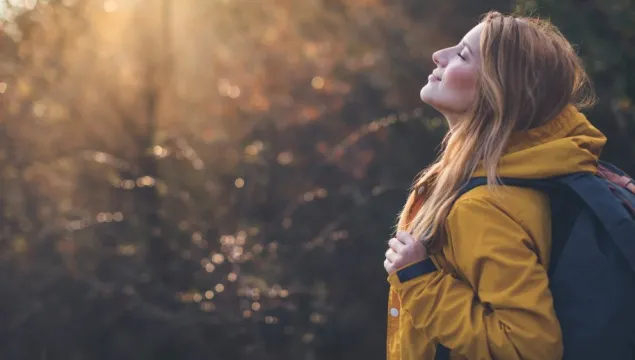 woman standing in sunlight 