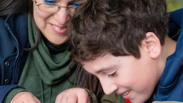 A child and adult dissecting owl pellets