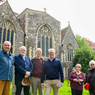 St Clement's churchyard volunteers posing with rob smith for the talk on the wild side podcast episode