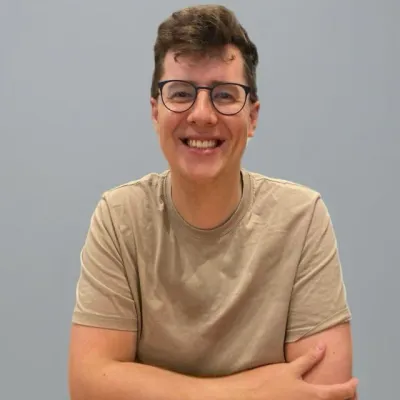 Robbie Still, Deputy Director (Digital Development) at KWT, smiling with arms crossed.