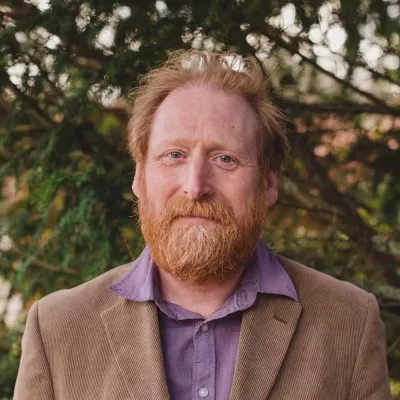 Vincent Ganley, Managing Director at ABEC, smiling in front of a woodland backdrop.