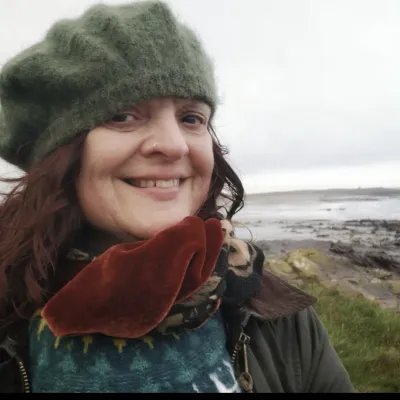 Rachel Rodwell, smiling by the sea shore.