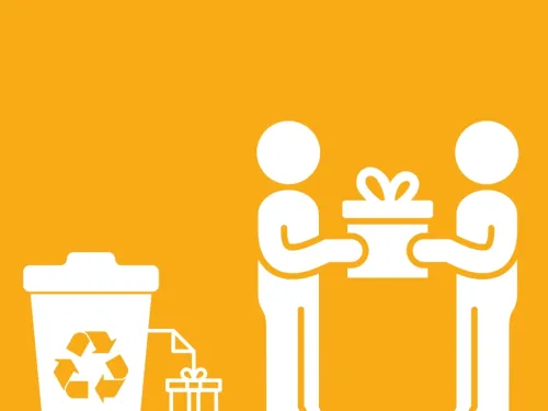 two people giving a gift next to a recycling bin