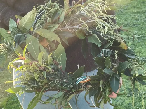A willow wreath covered with winter foliage