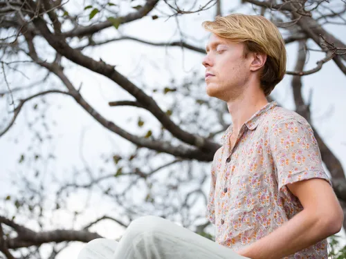 man meditating outside 