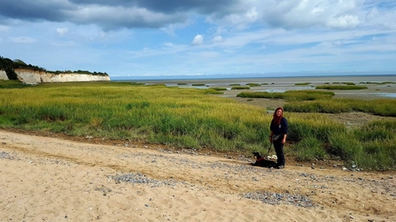 Dog with owner at tidal site