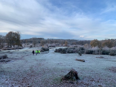 Volunteers at Hothfield Heathland in winter with frost on the grass.
