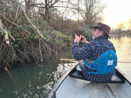 John Gisbey paddling canoe finding beaver activity