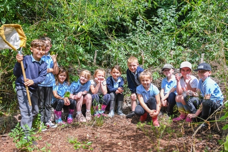 school visit kids smiling with pond dipping equipment